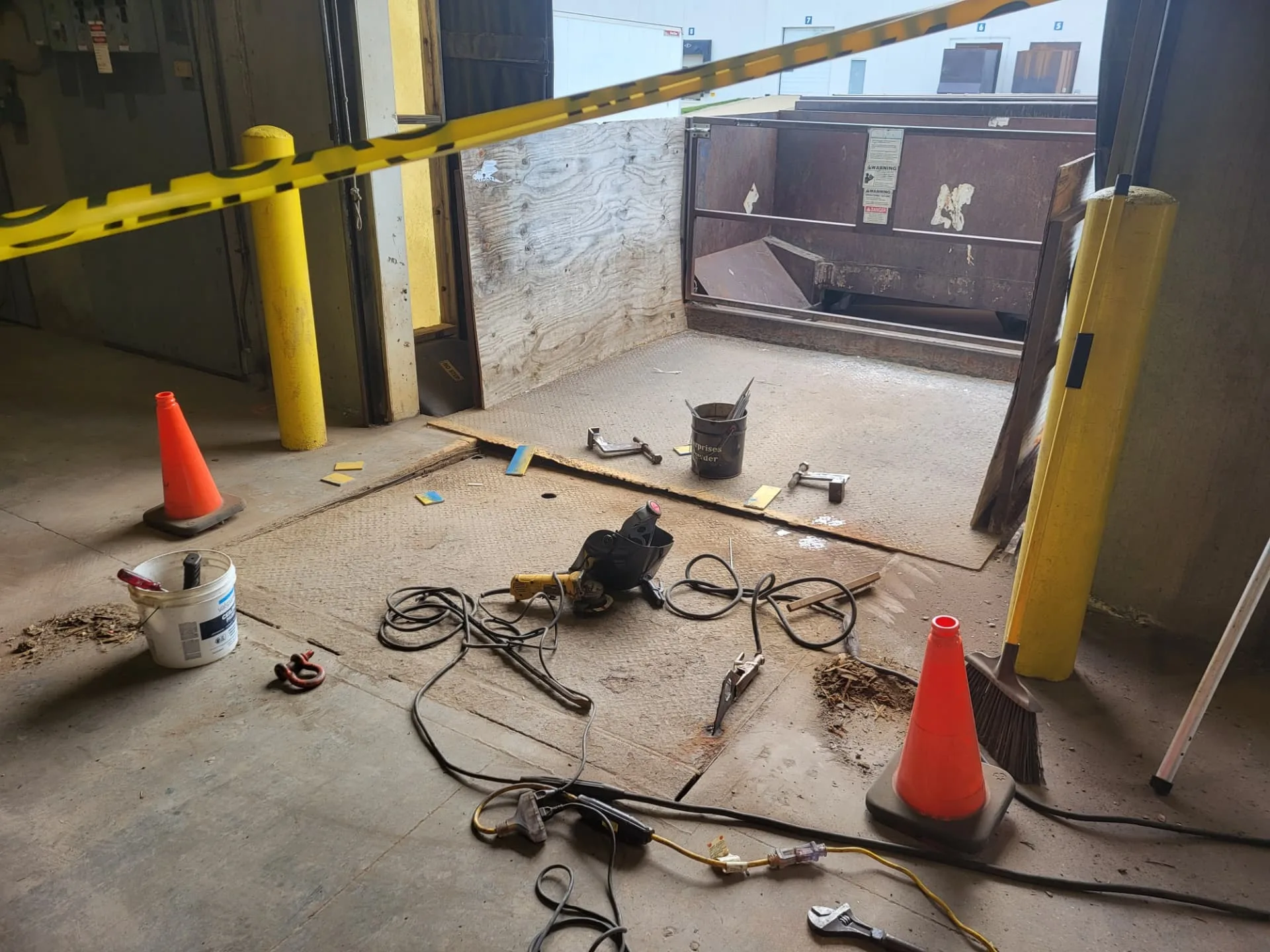 Tools laid out for an on-site loading dock plate repair by CinStar mobile welding