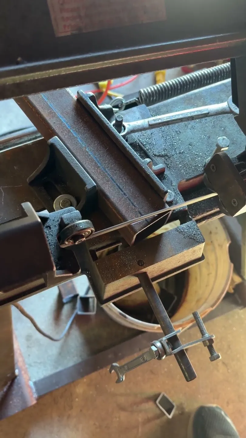 Video preview: a horizontal bandsaw cutting structural steel tubing to length in the CinStar shop