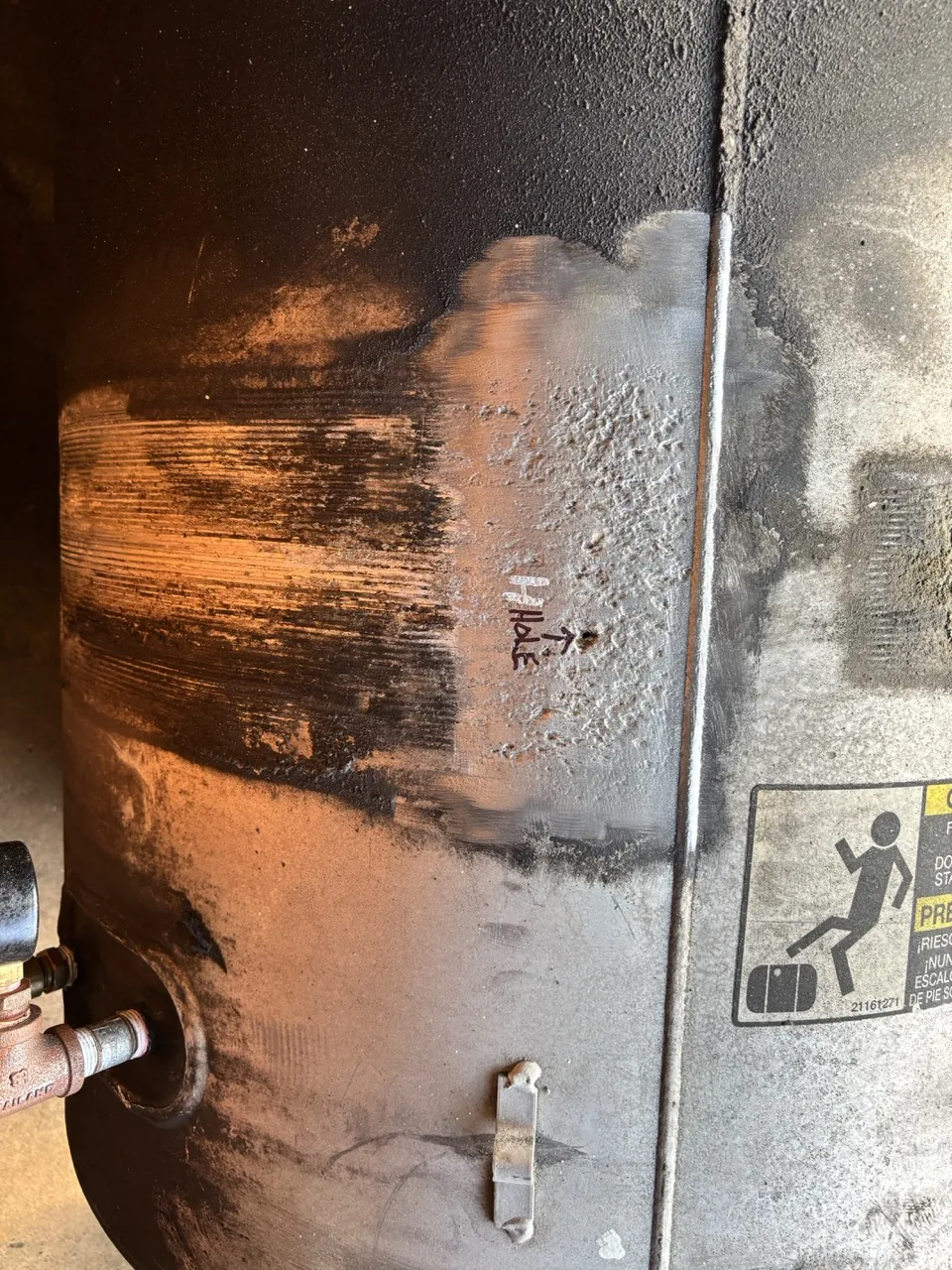 Corroded aluminum truck fuel tank along the mounting strap line, marked where the leak started, repaired by CinStar in Petersburg, Kentucky