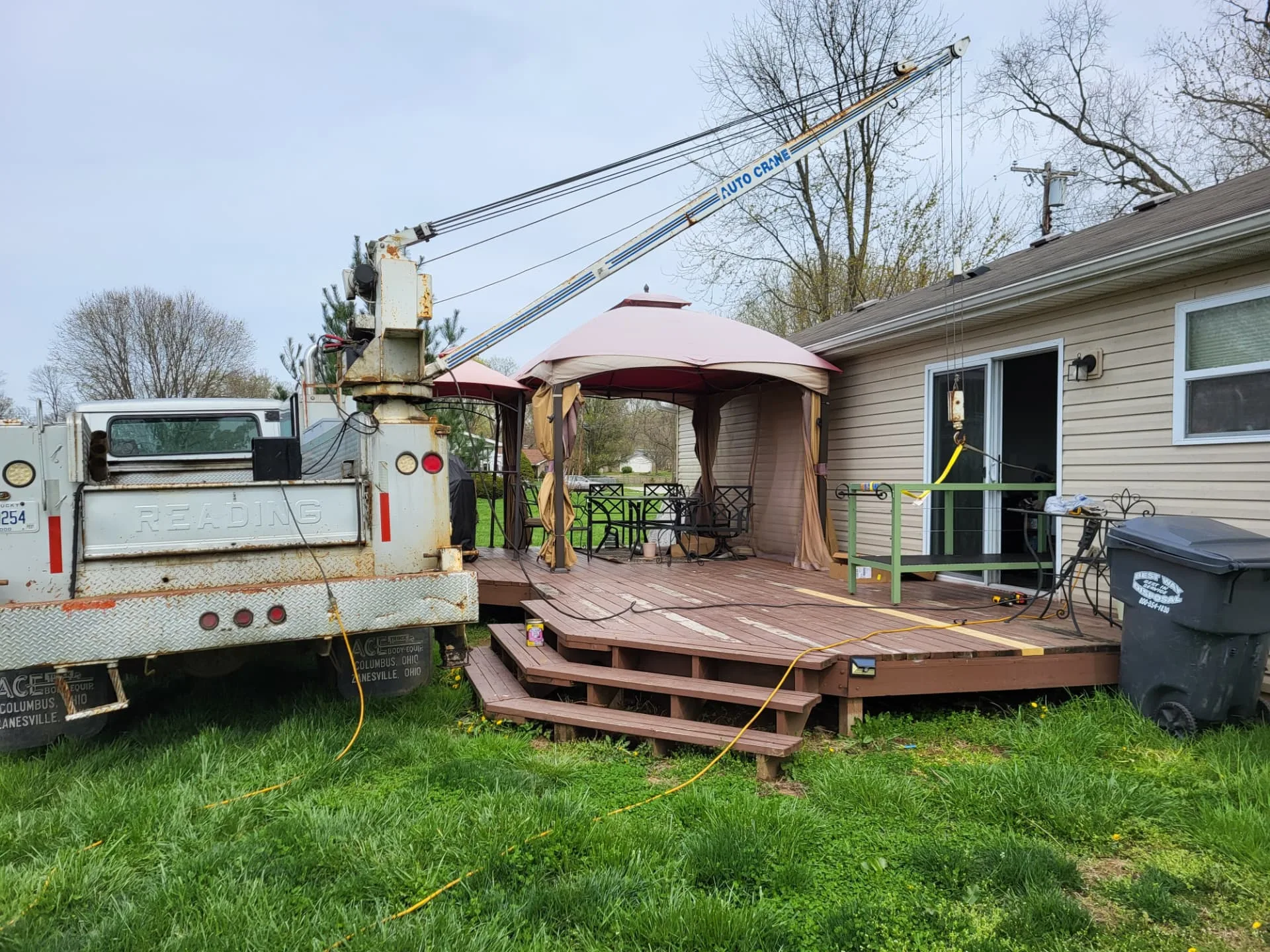 CinStar crane truck on site after setting the custom kitchen island base on the customer's deck