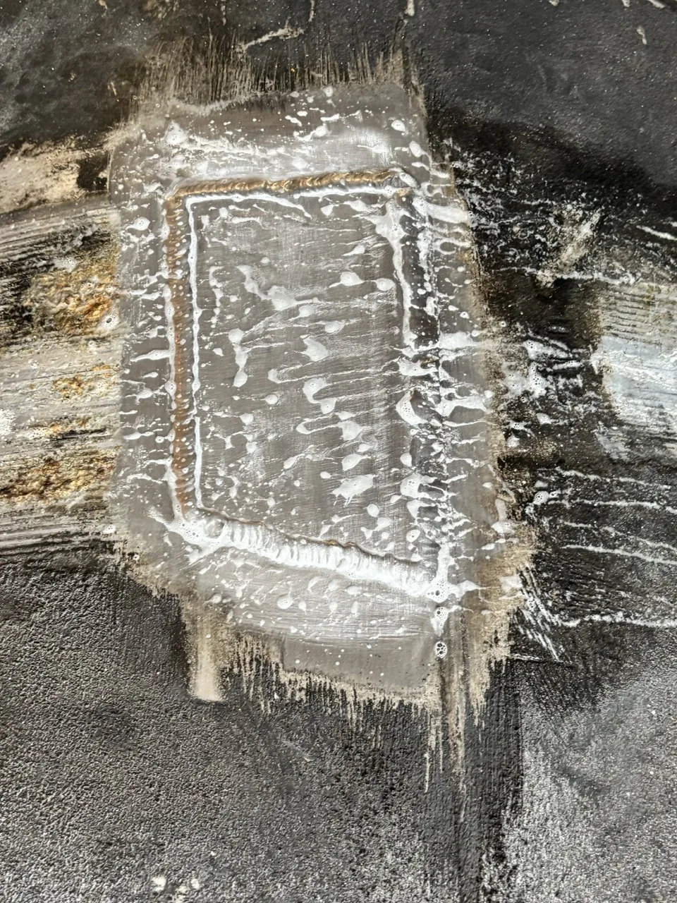 Aluminum patch plate welded over a fuel tank leak and covered in soap bubbles to prove it holds, by CinStar in Petersburg, Kentucky