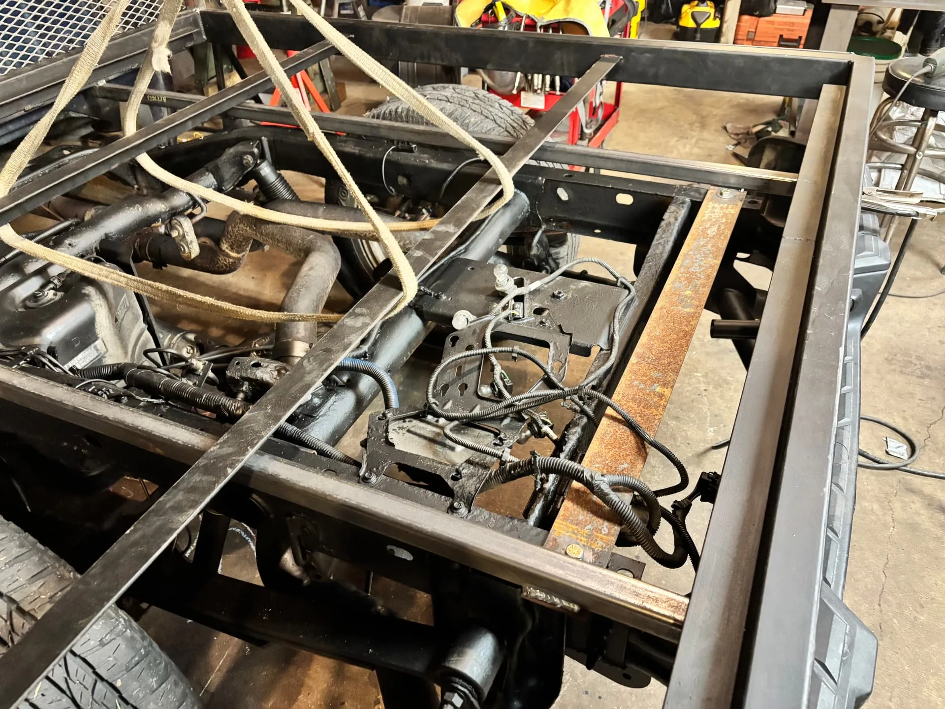 Crossmembers strapped and aligned during the flatbed build, CinStar in Petersburg, Kentucky