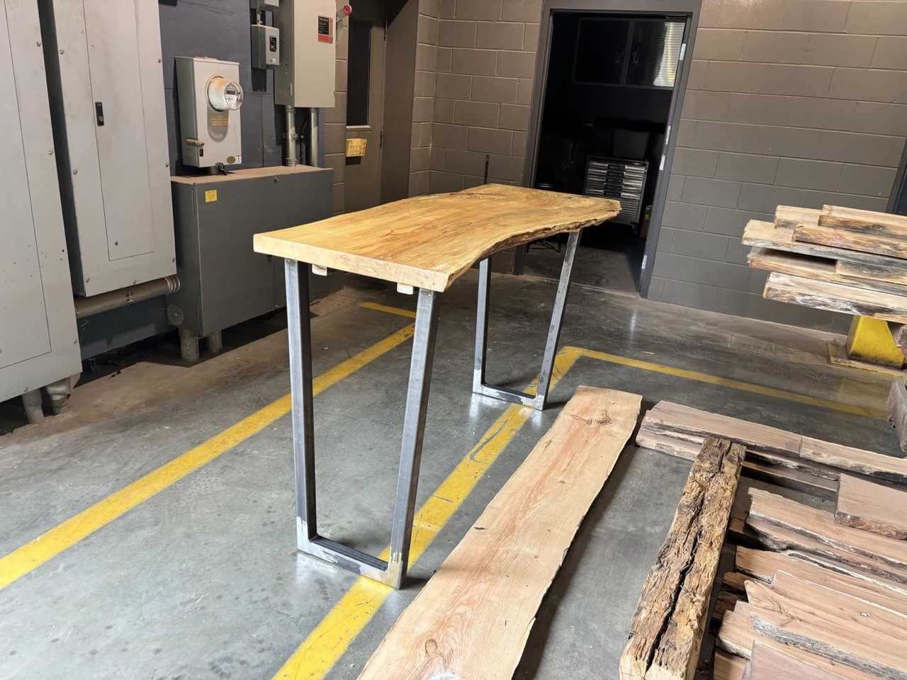 Live-edge wood console supported by CinStar-fabricated steel loop legs for Ohio Wood Connection