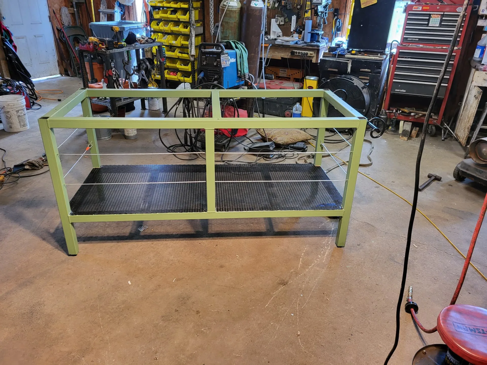 Second view of the finished sage green steel kitchen island base in the CinStar shop