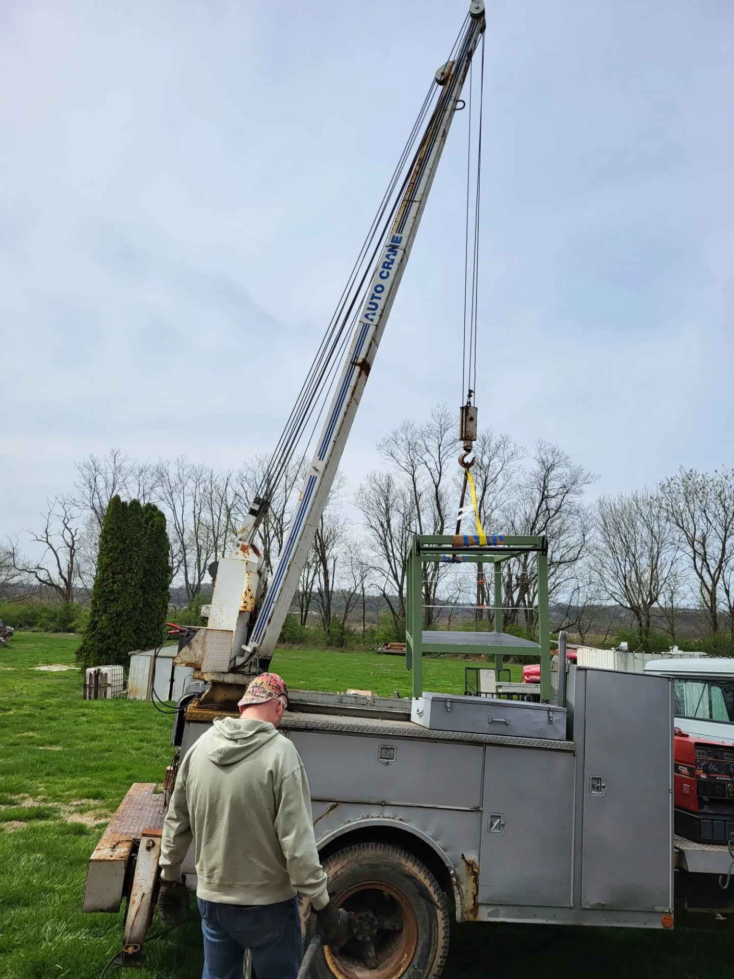 CinStar's crane truck lowering the kitchen island base into place at the customer's home