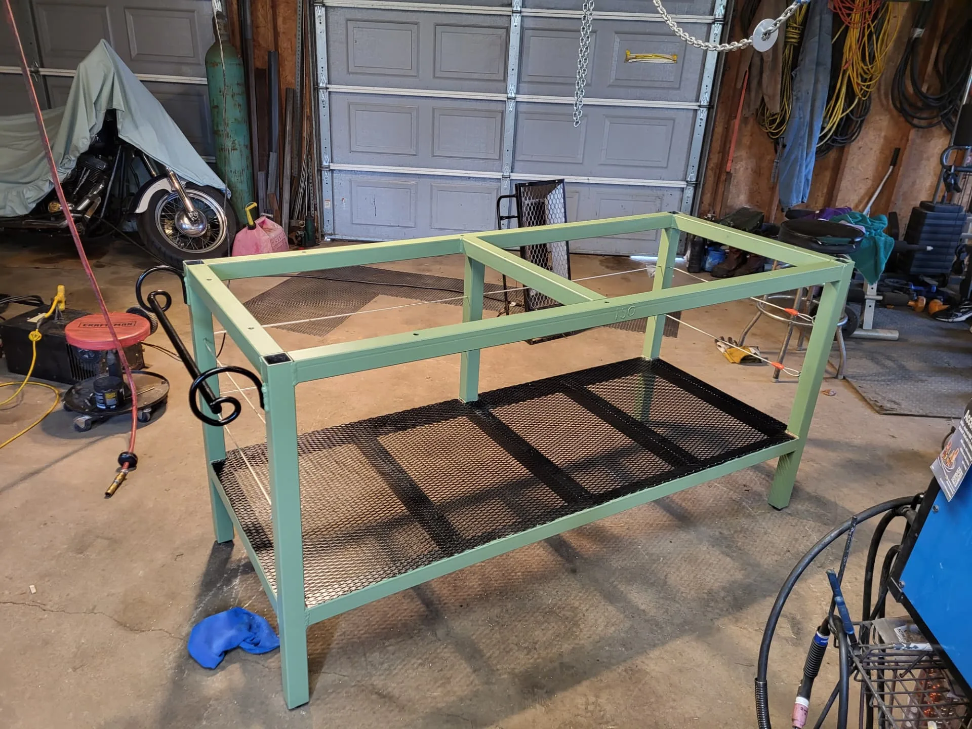 Finished sage green steel kitchen island base in the CinStar shop before delivery